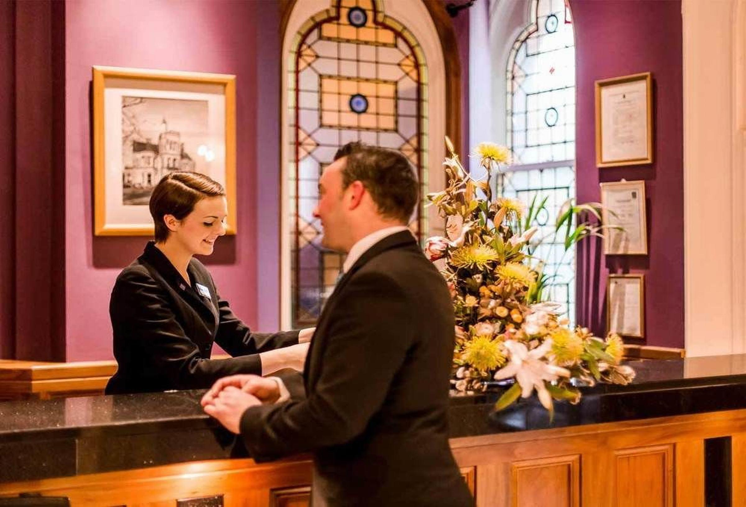 The Culloden Estate And Spa Holywood  Exteriér fotografie A hotel receptionist at work