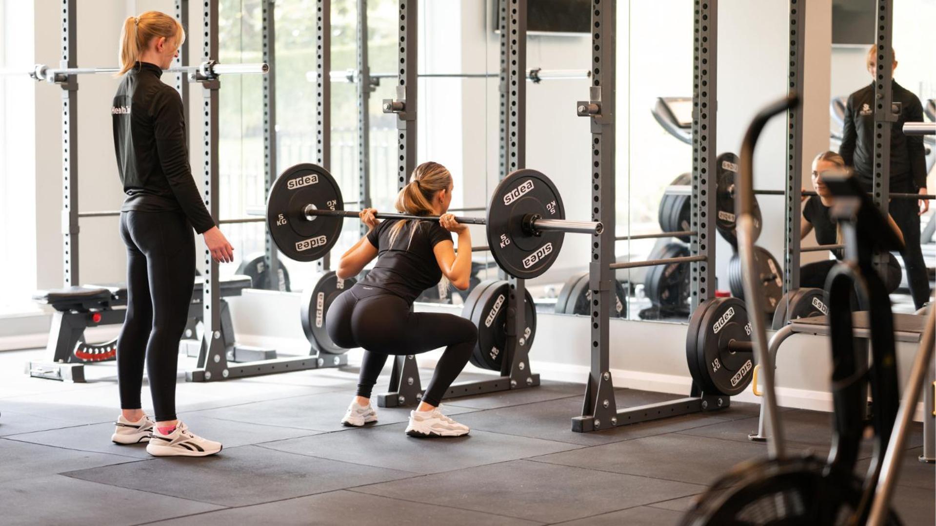 The Culloden Estate And Spa Holywood  Exteriér fotografie A woman performing a back squat with a barbell